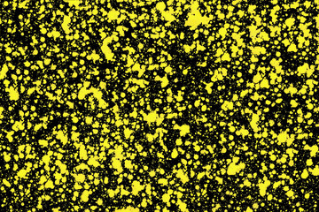 Yellow ink stains on black paper. Color splashes pattern. Blot splatter background. Spray texture for graphic design.
