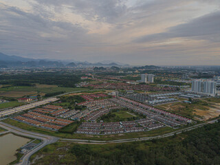 Drone shot from high angle view of residential area with many houses in Chemor, Ipoh, Perak, Malaysia.
