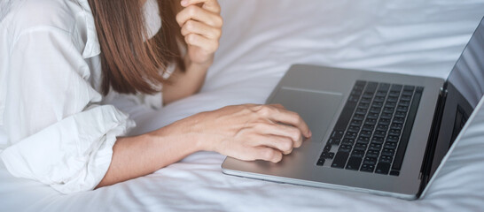 Happy woman using laptop for work, female meeting  online by computer notebook on bed. technology, network, work from home, lifestyle and digital communication concept
