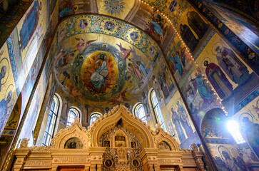 Fototapeta na wymiar Carved altar ornament and dome decorated with frescoes in the Church of the Savior on Spilled Blood in St. Petersburg, Russia