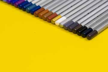 Colorful stationary school supplies on yellow trending background with copyspace or text flat lay. Colorful Education or back to school Concept