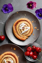 Fresh baked flaky cinnamon swirl pastry with sweet white fondant icing