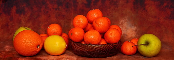Fruits, green apples, lemons, oranges and tangerines around a wooden bowl with a heap of tangerines. Widescreen wallpaper