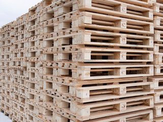 The pallets are located in a stack in the warehouse.