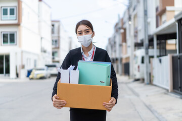 Asian business woman wear face mask after unemployment from company.