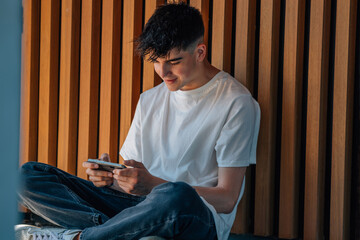 young boy with mobile phone on the street