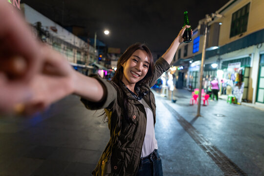 Asian woman backpacker use mobile phone selfie, take picture in city.