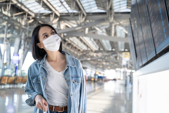 Caucasian woman passengers wear face mask walking in airport terminal. 
