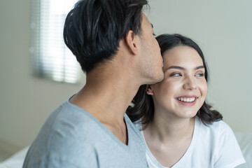 Asian attractive couple sitting together after wakeup in the morning. 