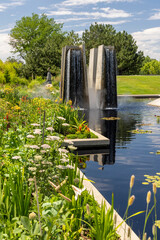 Tall structure with splashing water falls in Denver botanical gardens