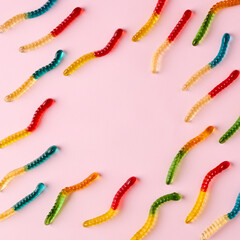 Gummy candies pattern on bright pink background with copy space.