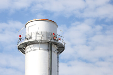 Industrial view of small silver color electric plant chimney.