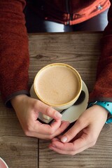 Beautiful woman hands holding coffee cup