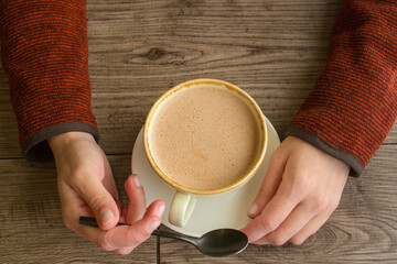 Beautiful woman hands holding coffee cup