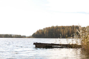 autumn landscape with small, unsharp boat pier in foreground.
