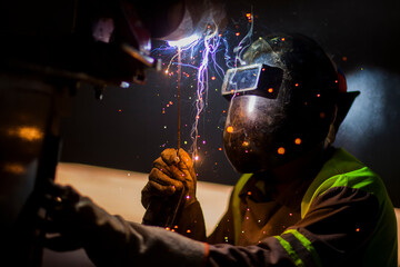 Man works on metal welding steel using electric welding machine to weld. High quality photo