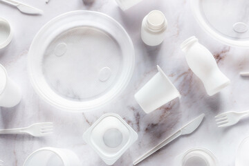disposable plastic tableware and cutlery close-up. concept of pollution of nature, ban of plastic dishes