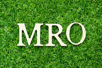 Alphabet letter in word MRO (Abbreviation of Maintenance, repair and overhaul or Maintenance, Repair and Operations) on green grass background - obrazy, fototapety, plakaty