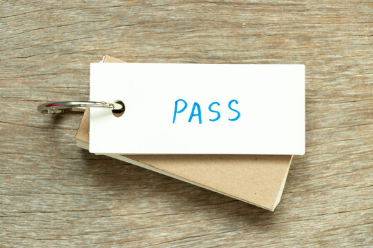 Flash card with handwriting word pass on wood background