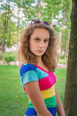 Portrait of a young beautiful girl in a summer park, close-up.