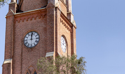 Twelve o'clock on clock bricked tower of Fredrikstad Cathedral in Norway