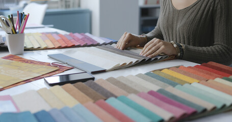 Woman selecting fabric swatches hands close up