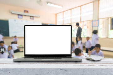 Modern laptop with blank screen on classroom desk