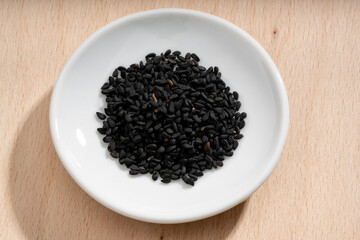Detailed and large close up shot of nigella on a small plate