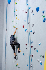climbing wall background. person climbing on wall