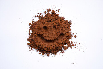 Ground coffee on a white background with a smiling face