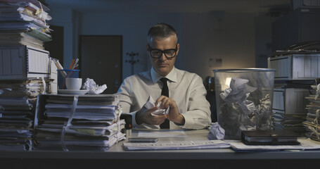 Businessman working and crumpling paper