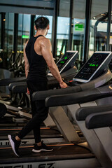 Obraz na płótnie Canvas Asian men wear black workout in fitness center