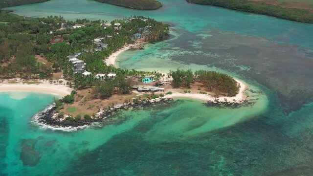 Tropical island with coco palm trees, wooden villas, white sand and turquoise crystal clear water, aerial view. Paradise island in Maldives, Bora Bora, Mauritius, Seychelles, Hawaii, Philippines