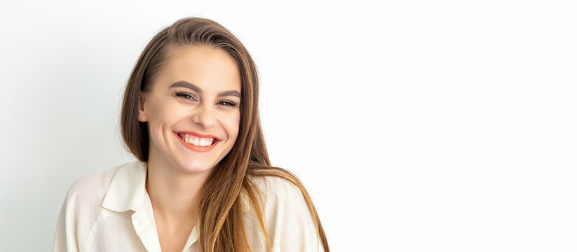 Beauty concept of woman. Portrait of a happy charming shy smiling young caucasian woman with long brown hair posing and looking at the camera over white background