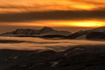 Snowy winter mountain landscape and colorful sky due sunrise over hill Dumbier in Low Tatras mountains at Slovakia