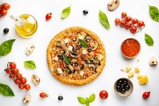 Tasty Vegetable Pizza And Cooking Ingredients Tomatoes And Basil On White Background. Top View