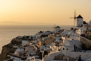Fototapeta na wymiar The windmills of Oia, Santorini, Greece, during the golden hour