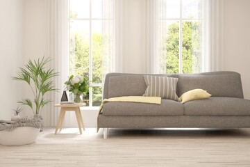 White living room with sofa and summer landscape in window. Scandinavian interior design. 3D illustration