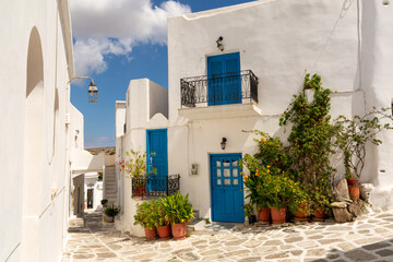 Fototapeta na wymiar White houses with blue shutters in Lefkes, Paros, Greece