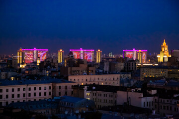 Obraz premium Evening (night) illuminated Soviet office building of Novyi Arbat on deep blue sky. Panoramic birds-eye view photo.