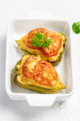stuffed bell peppers in baking dish. Copy space.