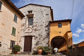 Fototapeta na wymiar Serravalle Pistoiese, Pistoia, Tuscany, Italy: the medieval church of San Michele Arcangelo and the 17th century portico in the ancient Tuscan village