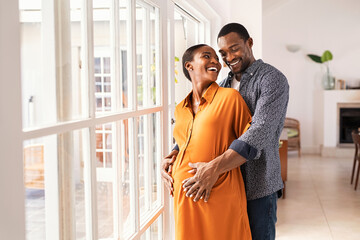 Husband embracing pregnant woman from behind - Powered by Adobe