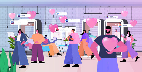 loving businesspeople celebrating happy valentines day men women in love using digital gadgets office interior