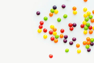 Colored dragee on a white background. Fruit sweets. Bright background. 
