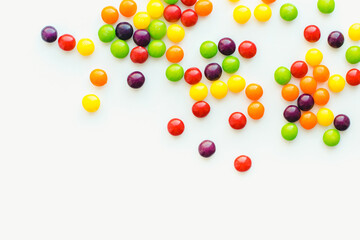 Colored dragee on a white background. Fruit sweets. Bright background. 