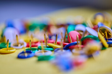 Colorful thumbtacks close up macro shot, shallow depth of field, image for background.