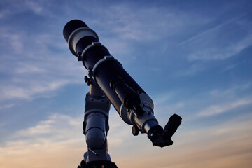 Fototapeta Big astronomical telescope under a twilight sky ready for stargazing. obraz