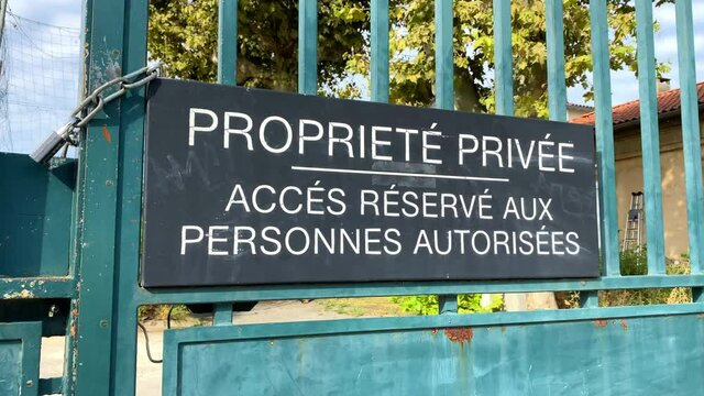 "Private property reserved for authorized persons" French sign at a gate of a private property