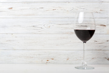 One glasses of red wine at wine tasting. Concept of red wine on colored background. Top view, flat lay design